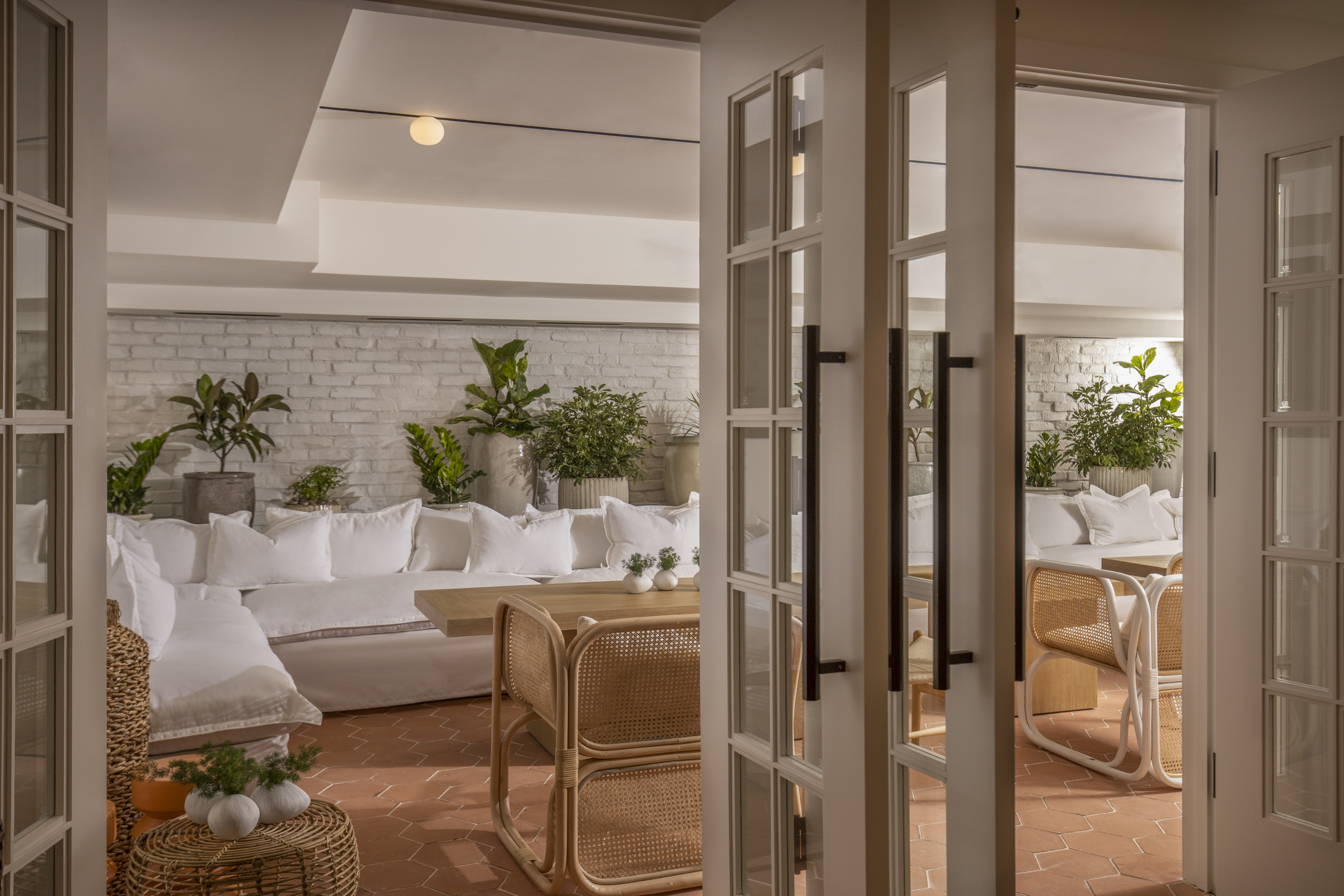Glimpse of the white couches through the open Conservatory doors